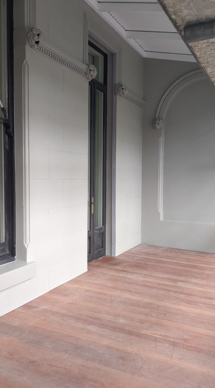 Restored window surround, scroll corbels and arched recess on the finished Brunswick verandah wall