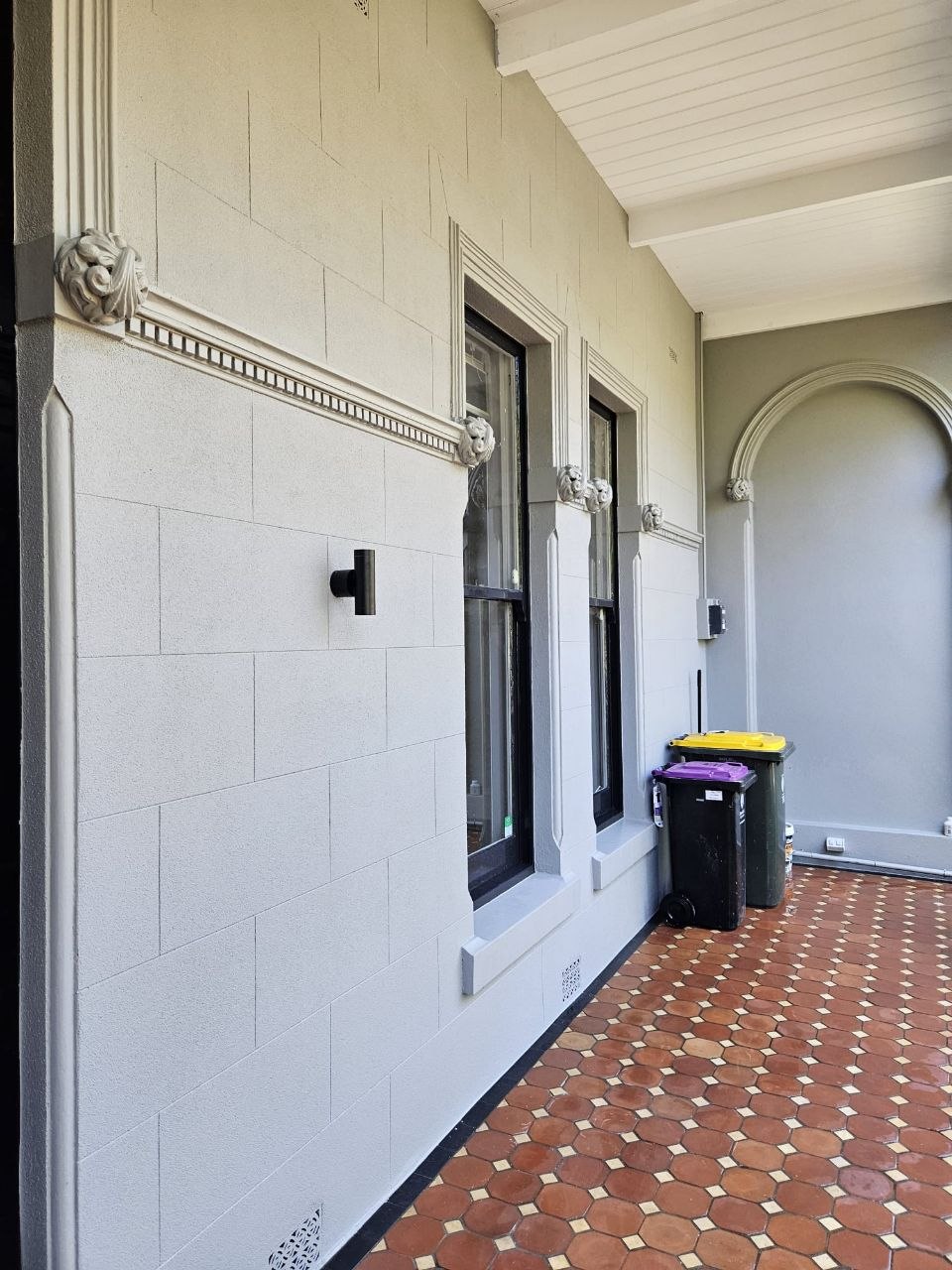 Recreated ashlar blockwork, dentil course and scroll corbels on the finished Brunswick render