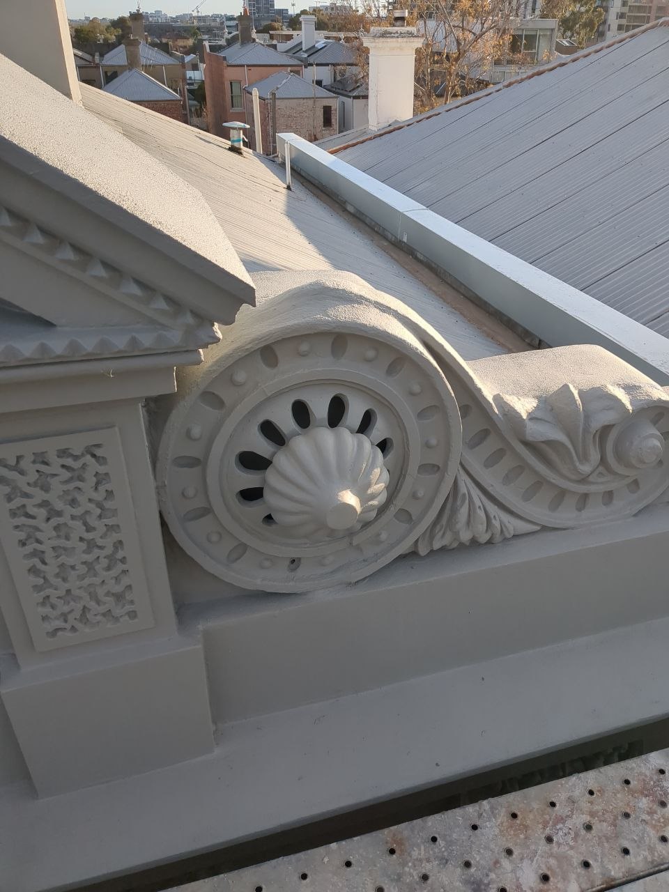 Reinstated parapet scroll, dentil moulding and pierced panel on the restored Brunswick facade