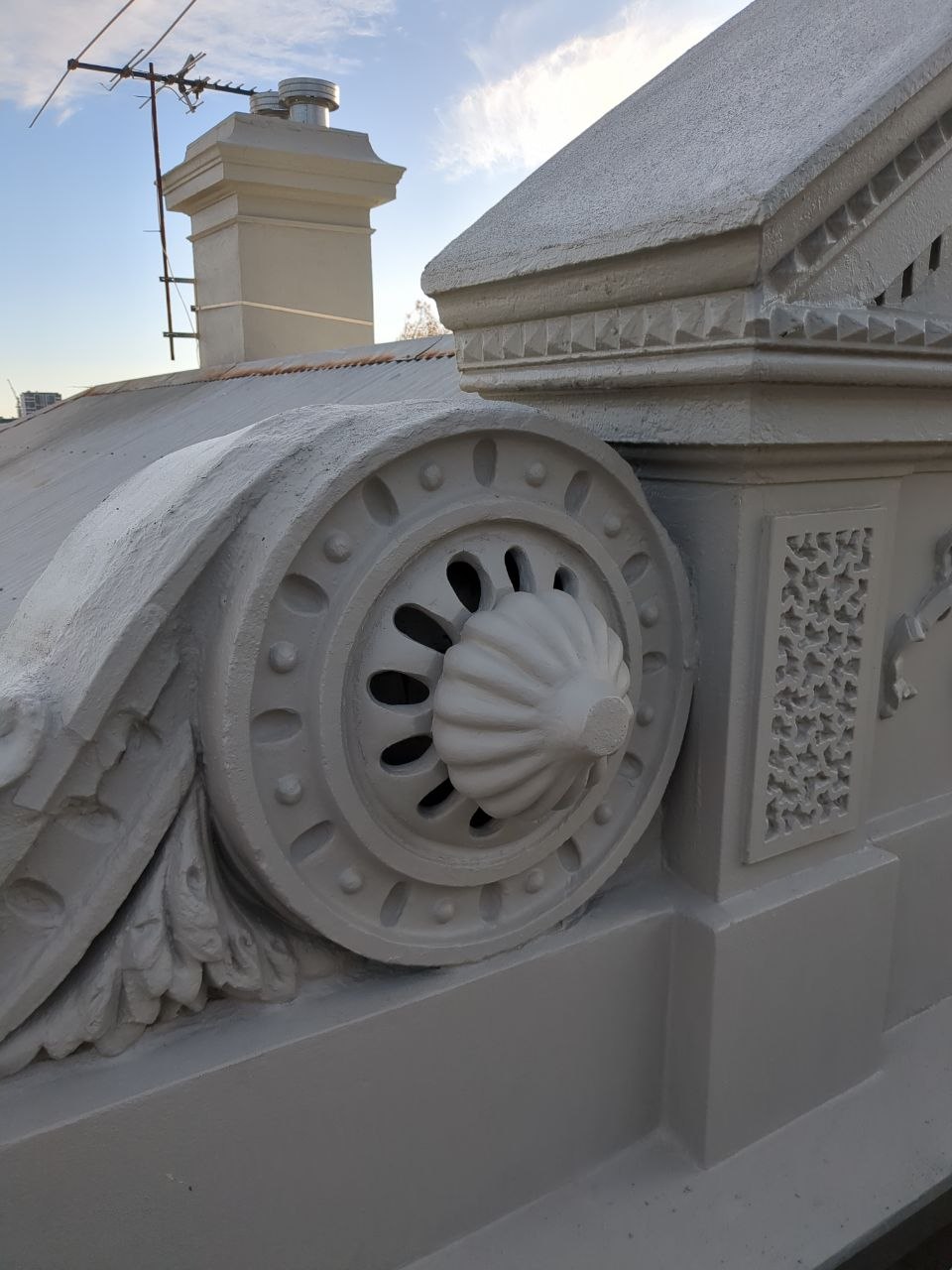 Restored decorative parapet scroll and rosette after render reproduction at Brunswick
